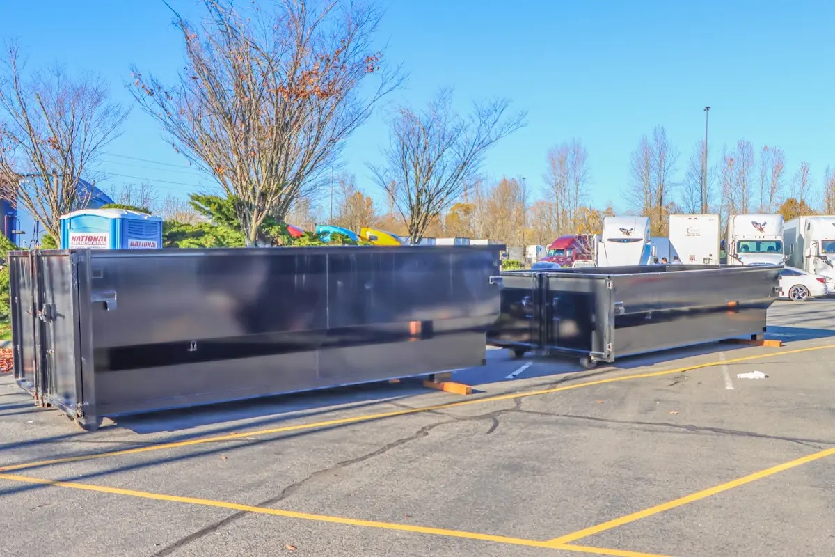 Professional dumpster rental service with roll-off container on residential driveway in Decatur